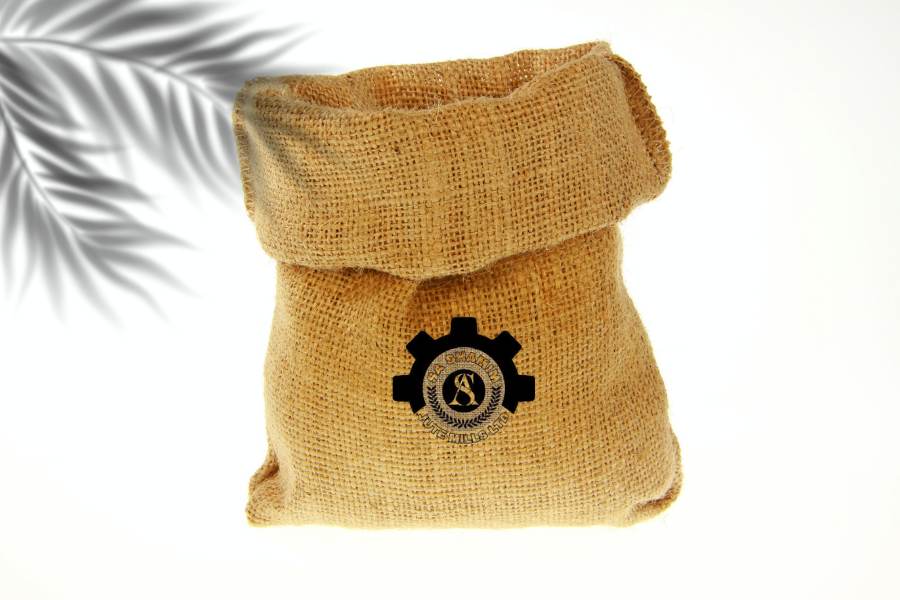 A collection of high-quality jute bags in various sizes and designs, produced by SA Shamim Jute Mills Ltd, showcasing their durability, versatility, and eco-friendly nature. The bags are arranged against a natural, green background, highlighting their sustainable appeal